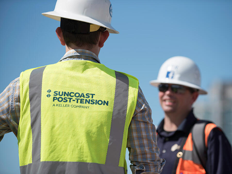 Two men on site talking