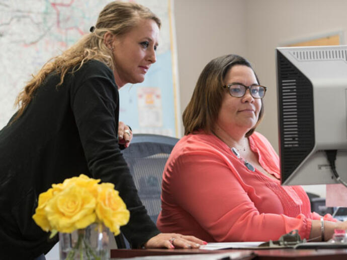 Two employees at a computer