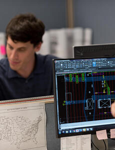 Two engineers at their desks